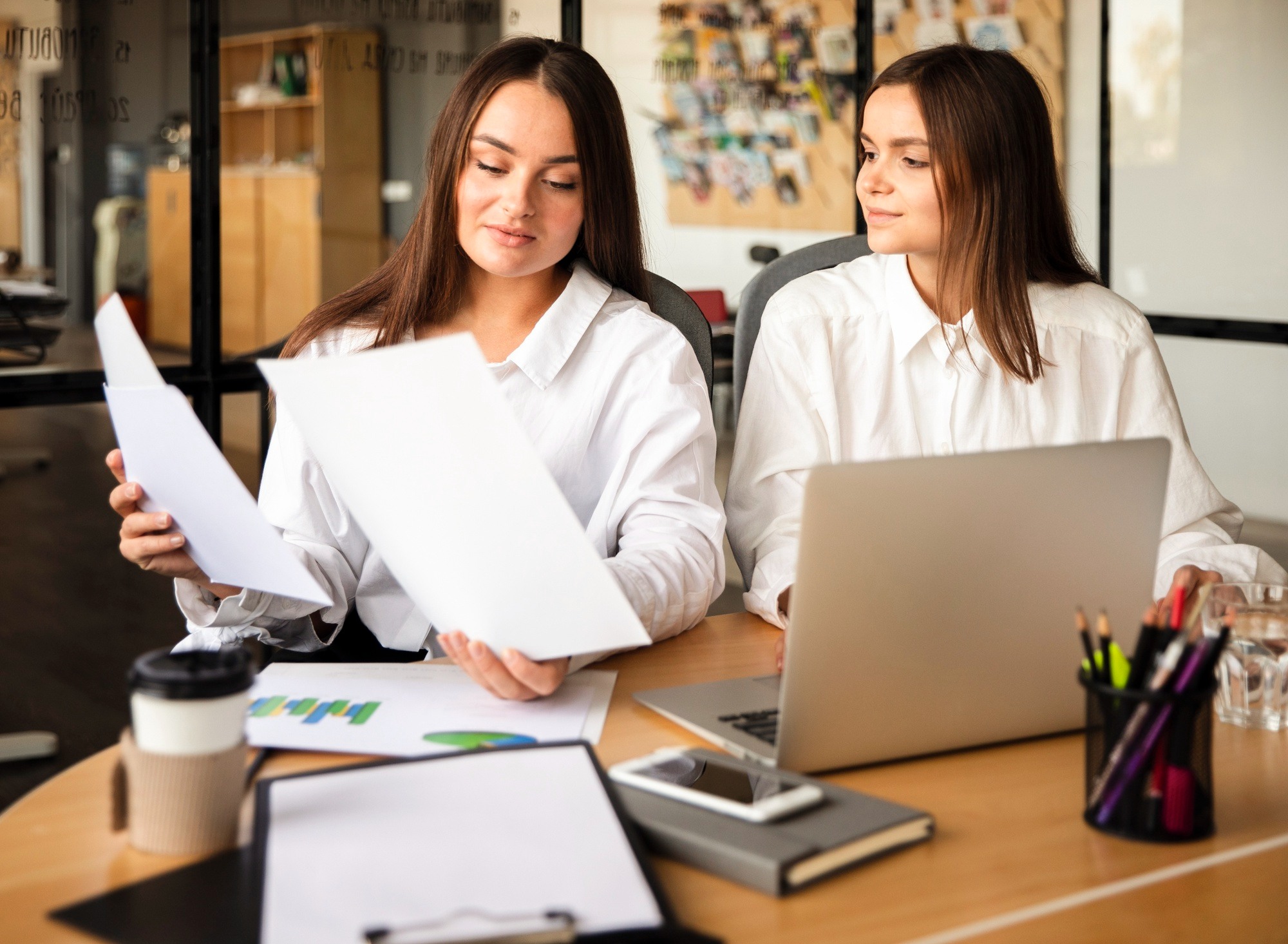 A professional and modern office setting with a focus on accounting services, featuring a team of accountants working collaboratively in a clean and organized environment, emphasizing trust and reliability, showcasing the company's history and core values, with a neutral color palette to align with the website's design style, no distracting elements, no specific art style or color adjectives